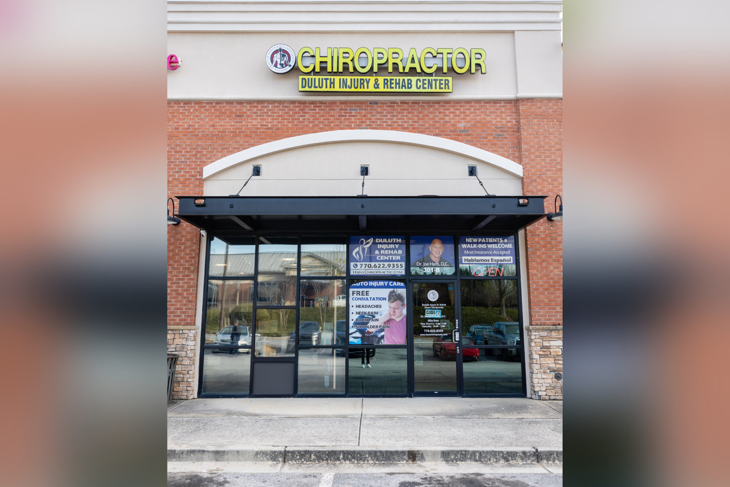 Entrance of a chiropractic clinic with signage and advertisement banners.